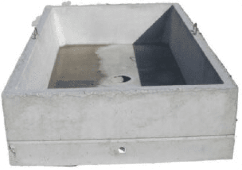 Concrete water trough with drainage hole, viewed from front angle.