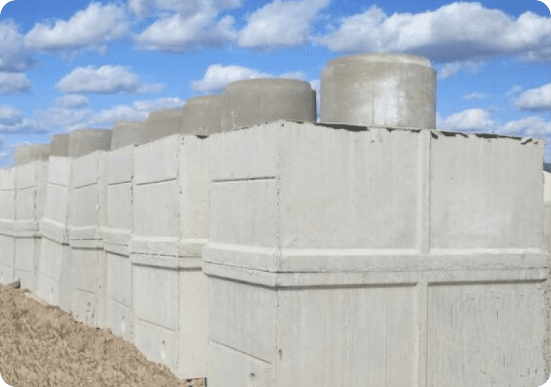 Concrete blocks stacked outdoors on a sunny day under a partly cloudy sky.